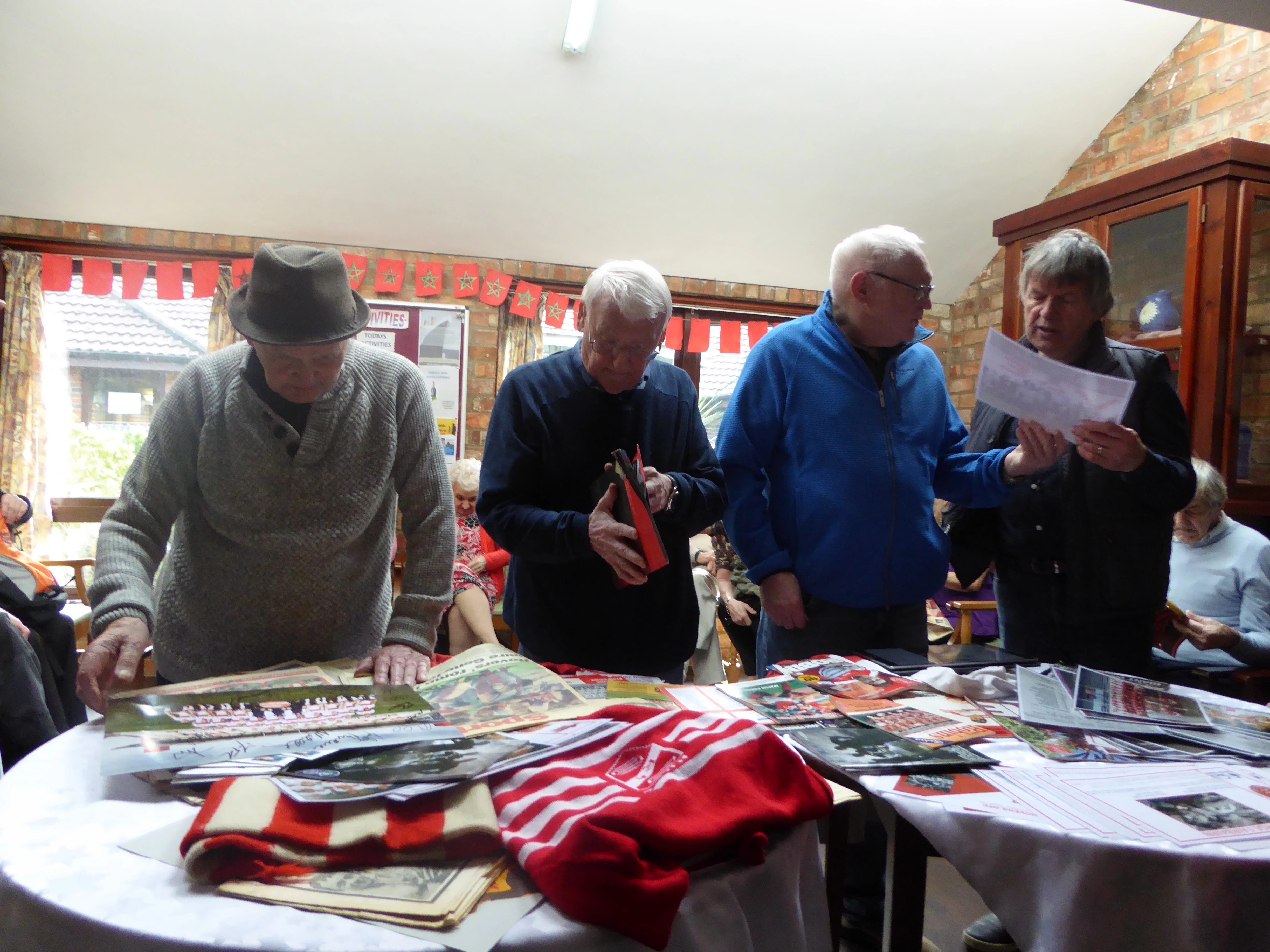 Residents at Elm Tree Court looking over Hull KR memorabilia 