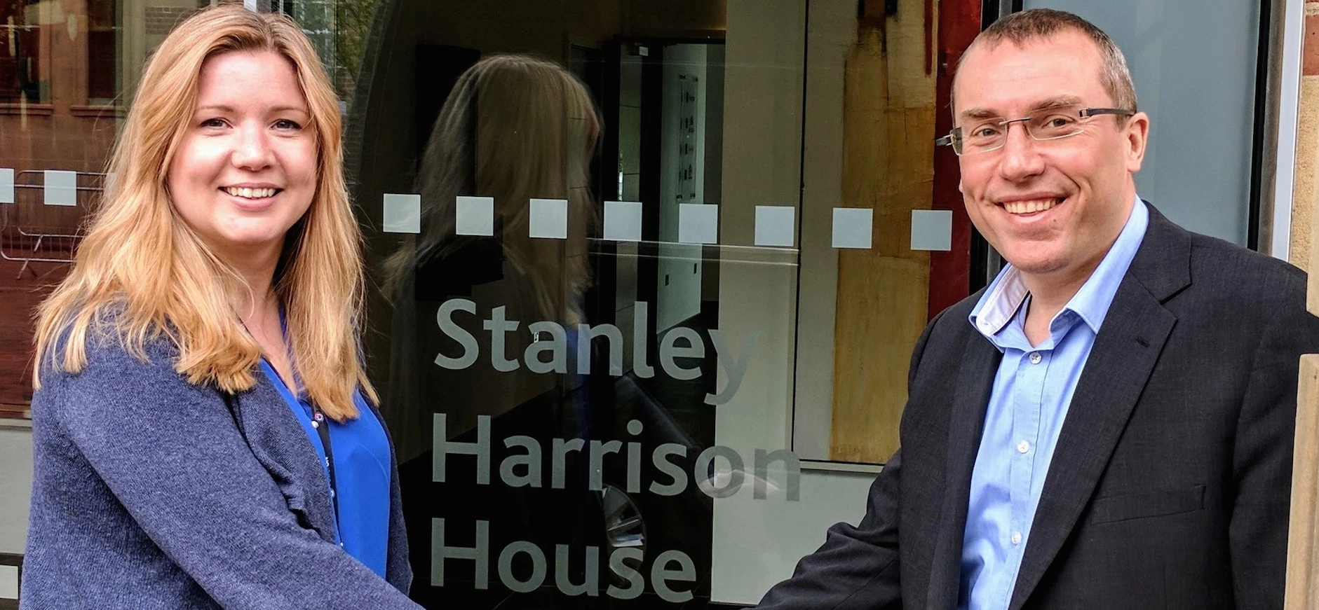 Vicky Harmer from PowerON and Phil Hill from S Harrison celebrate moving into Stanley Harrison House in York.