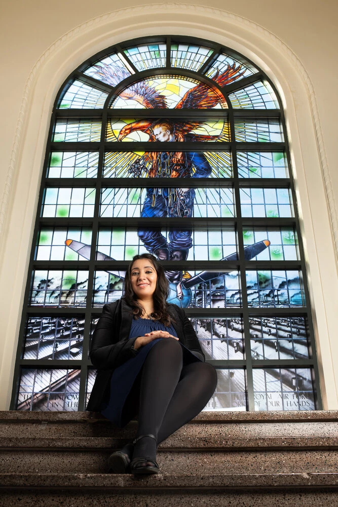 pictured: Connect Derby’s Ann Bhatti in front of the iconic stained-glass window at Marble Hall