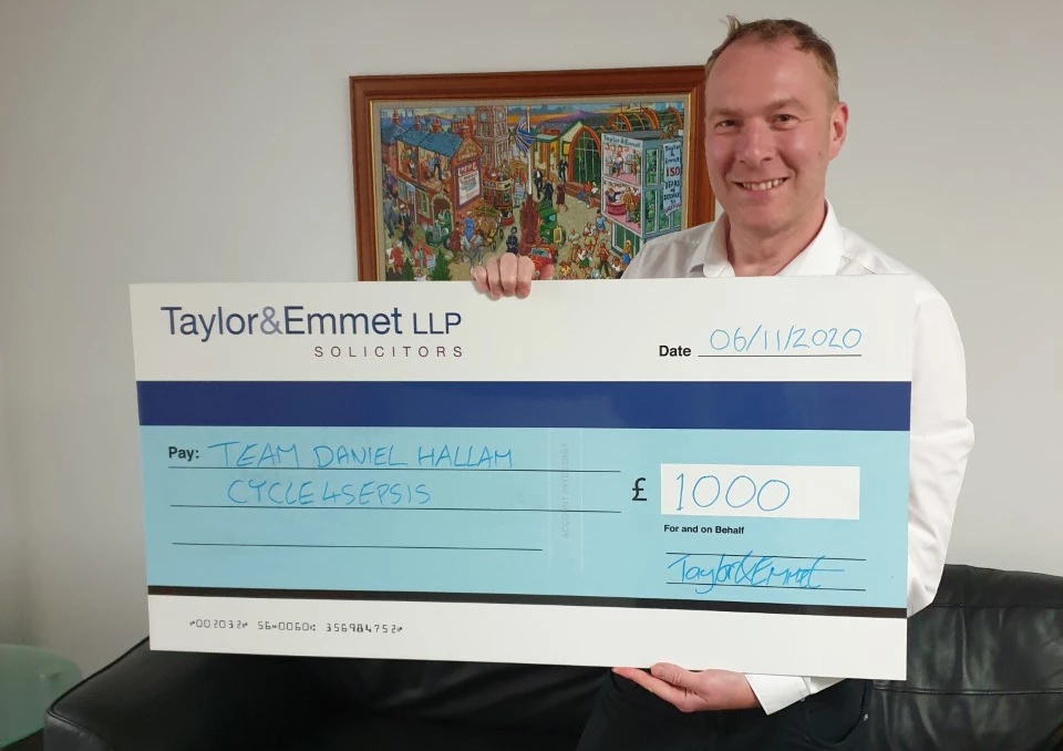 Alex Watkinson, Taylor&Emmet's head of contentious probate, with the firm's donation to TeamDanielHallam.